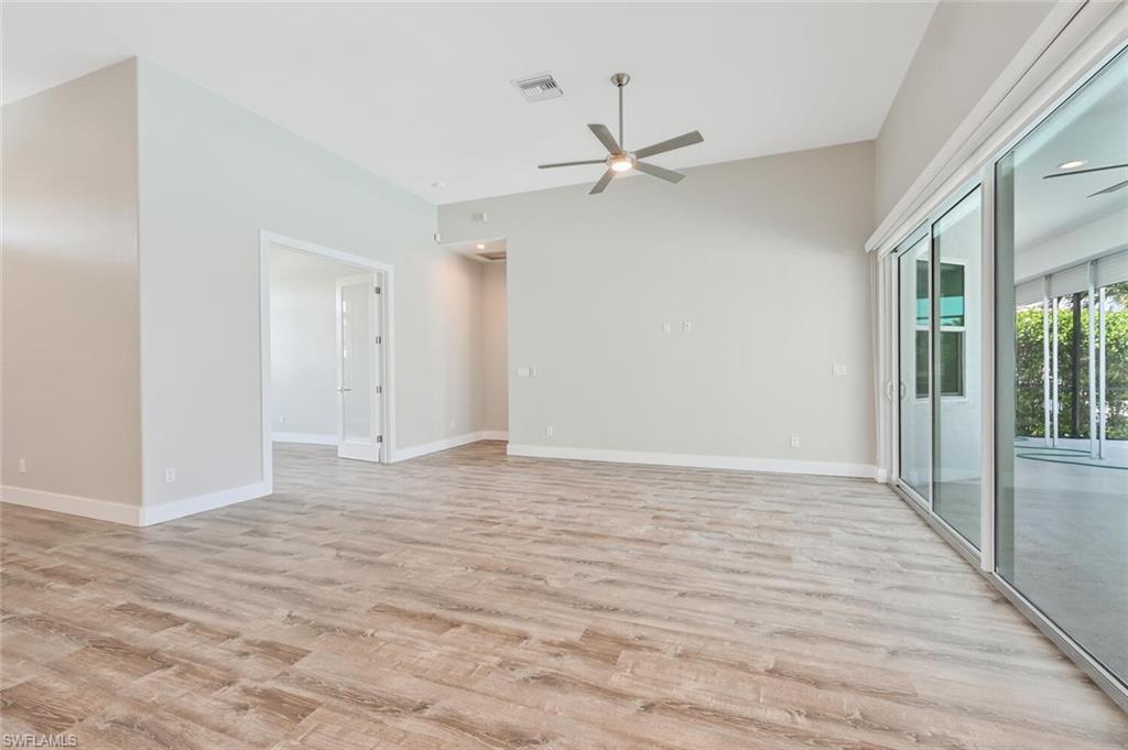 4231 Crayton Road Naples, FL 34103 - Photo 6 of 46 a view of an empty room with wooden floor