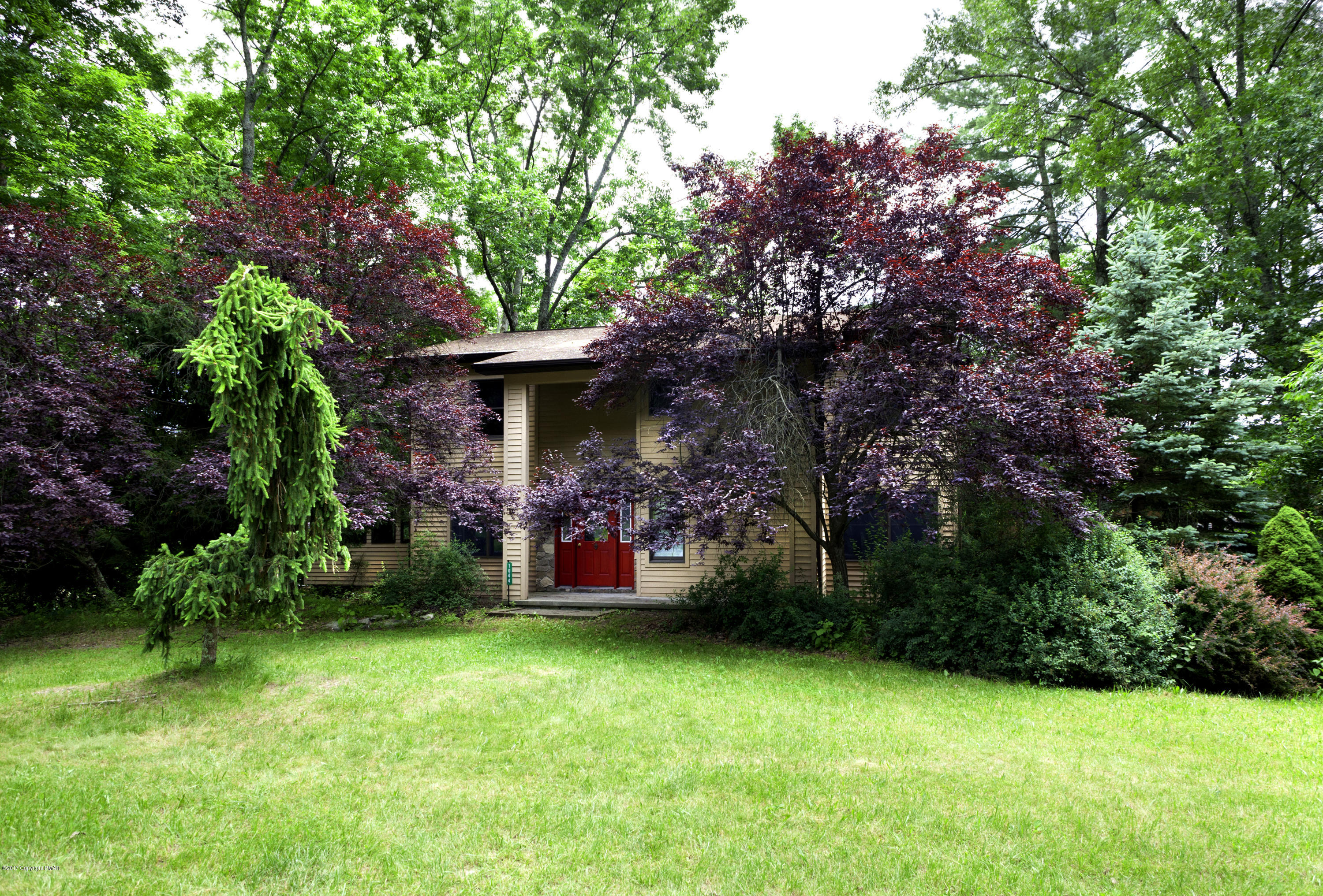 a view of a backyard with a garden and entertaining space