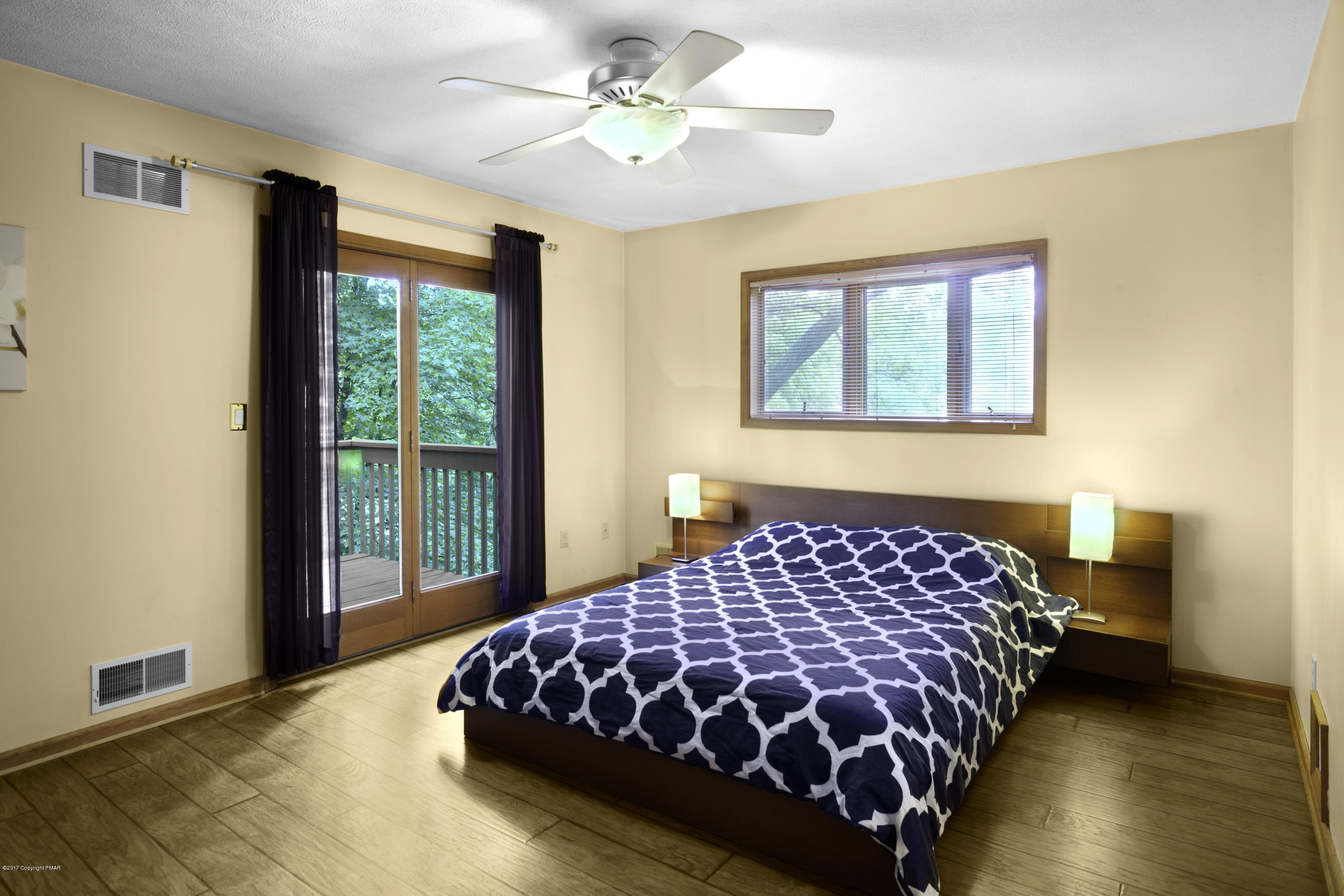 1044 Upper Ridge View Drive East Stroudsburg, PA 18302 - Photo 11 of 27 a bedroom with a large bed and a window