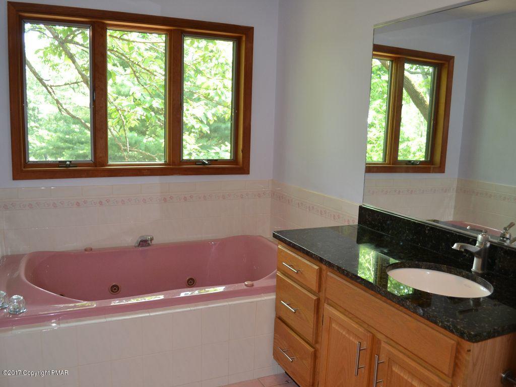 1044 Upper Ridge View Drive East Stroudsburg, PA 18302 - Photo 12 of 27 a bathroom with a granite countertop tub a sink and a window