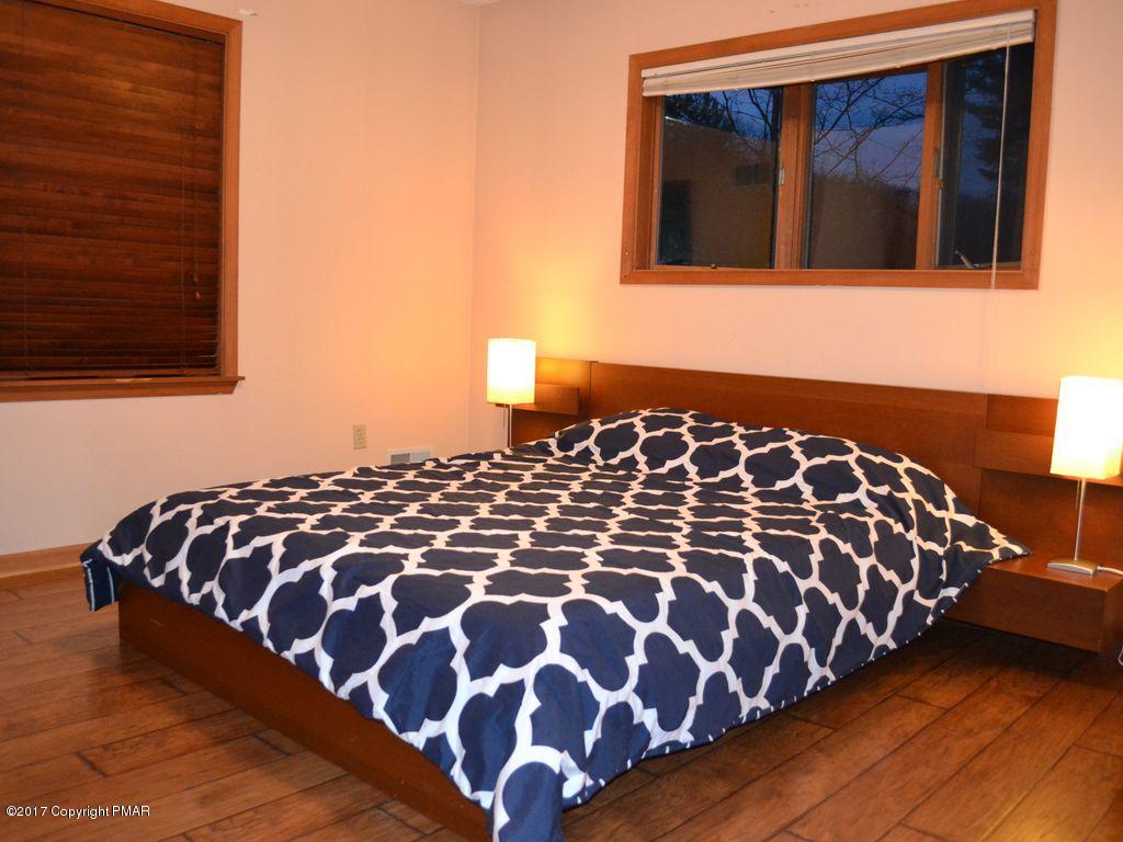 1044 Upper Ridge View Drive East Stroudsburg, PA 18302 - Photo 15 of 27 a bed sitting in a bedroom next to a window