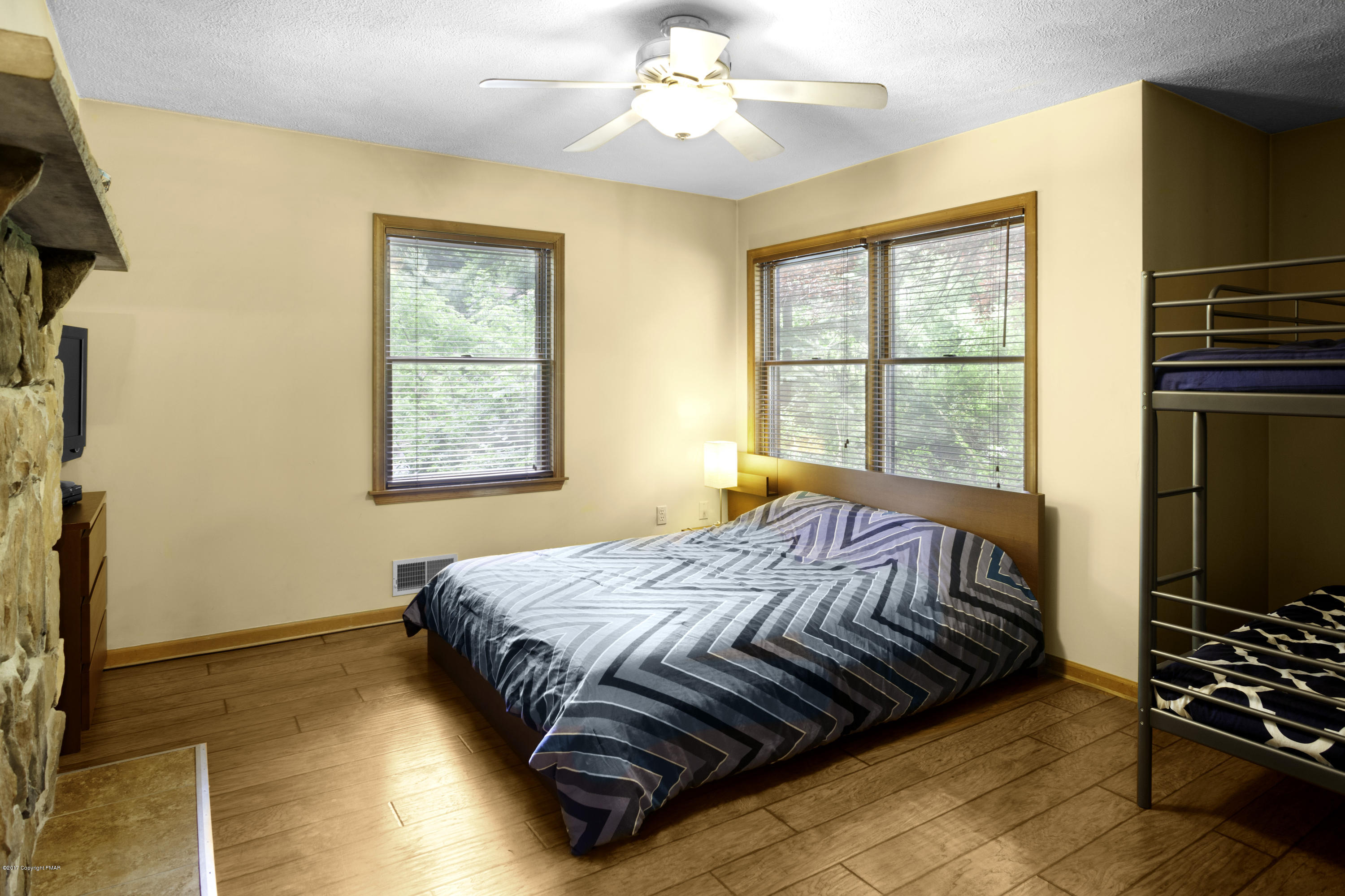 1044 Upper Ridge View Drive East Stroudsburg, PA 18302 - Photo 17 of 27 a bed sitting in a bedroom next to a window