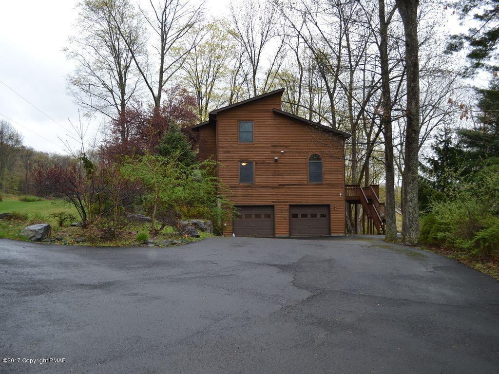 1044 Upper Ridge View Drive East Stroudsburg, PA 18302 - Photo 2 of 27 a view of a house with a yard and garage