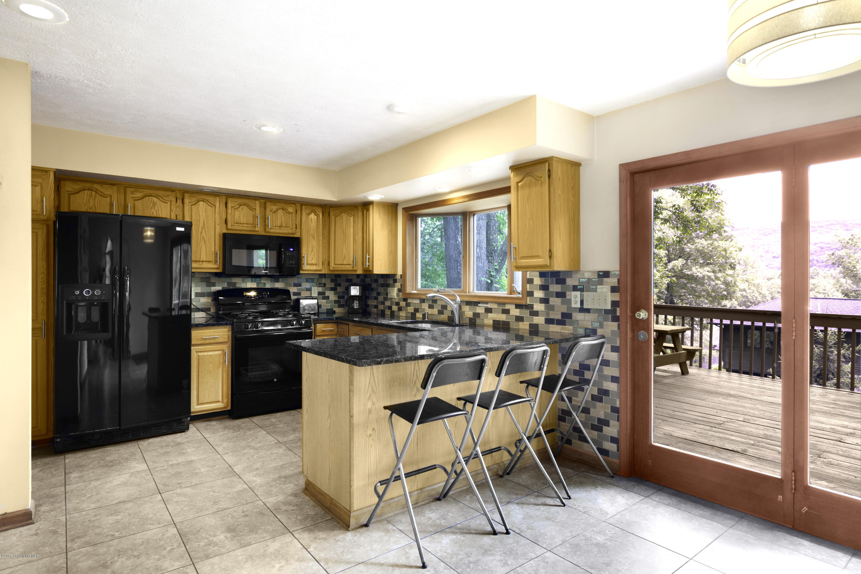 1044 Upper Ridge View Drive East Stroudsburg, PA 18302 - Photo 6 of 27 a kitchen with stainless steel appliances kitchen island granite countertop a refrigerator and cabinets