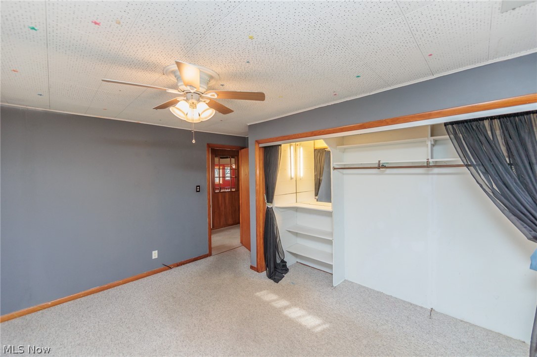 38565 Sugar Ridge Road North Ridgeville, OH 44039 - Photo 32 of 49 Unfurnished bedroom with light colored carpet, a closet, and ceiling fan