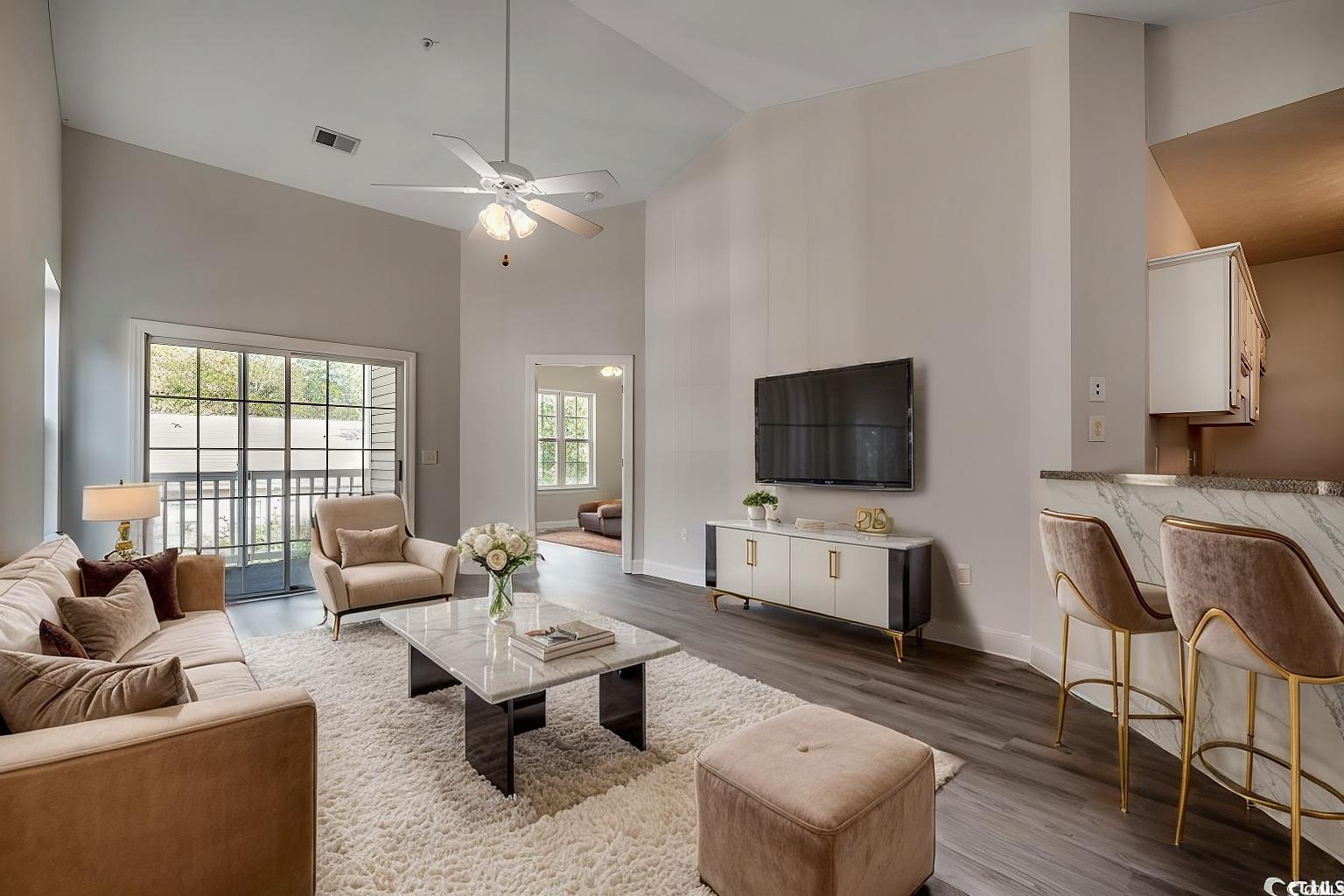 999 Algonquin Drive, Unit E Pawleys Island, SC 29585 - Photo 2 of 37 Living room with high vaulted ceiling, visible vents, baseboards, wood finished floors, and a ceiling fan