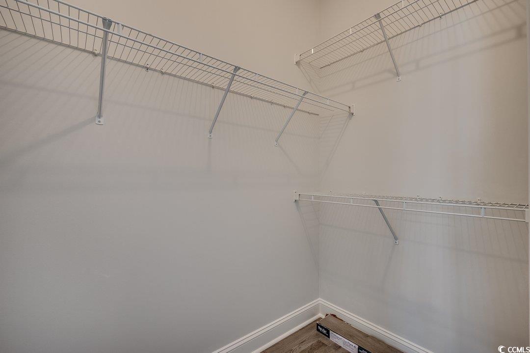 999 Algonquin Drive, Unit E Pawleys Island, SC 29585 - Photo 21 of 37 Spacious closet featuring wood finished floors
