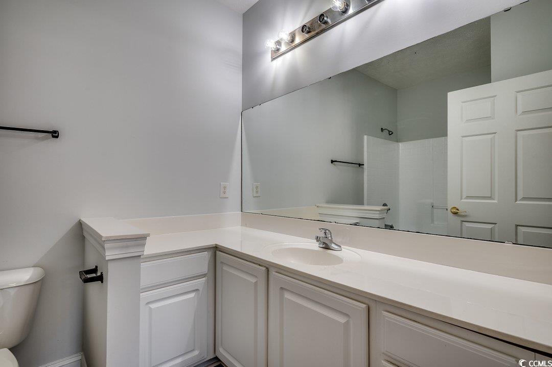 999 Algonquin Drive, Unit E Pawleys Island, SC 29585 - Photo 22 of 37 Full bath featuring toilet, walk in shower, and vanity