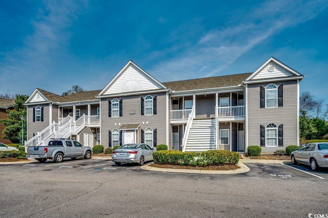 999 Algonquin Drive, Unit E Pawleys Island, SC 29585 - Photo 28 of 37 Multi unit property with covered porch, stairs, and uncovered parking