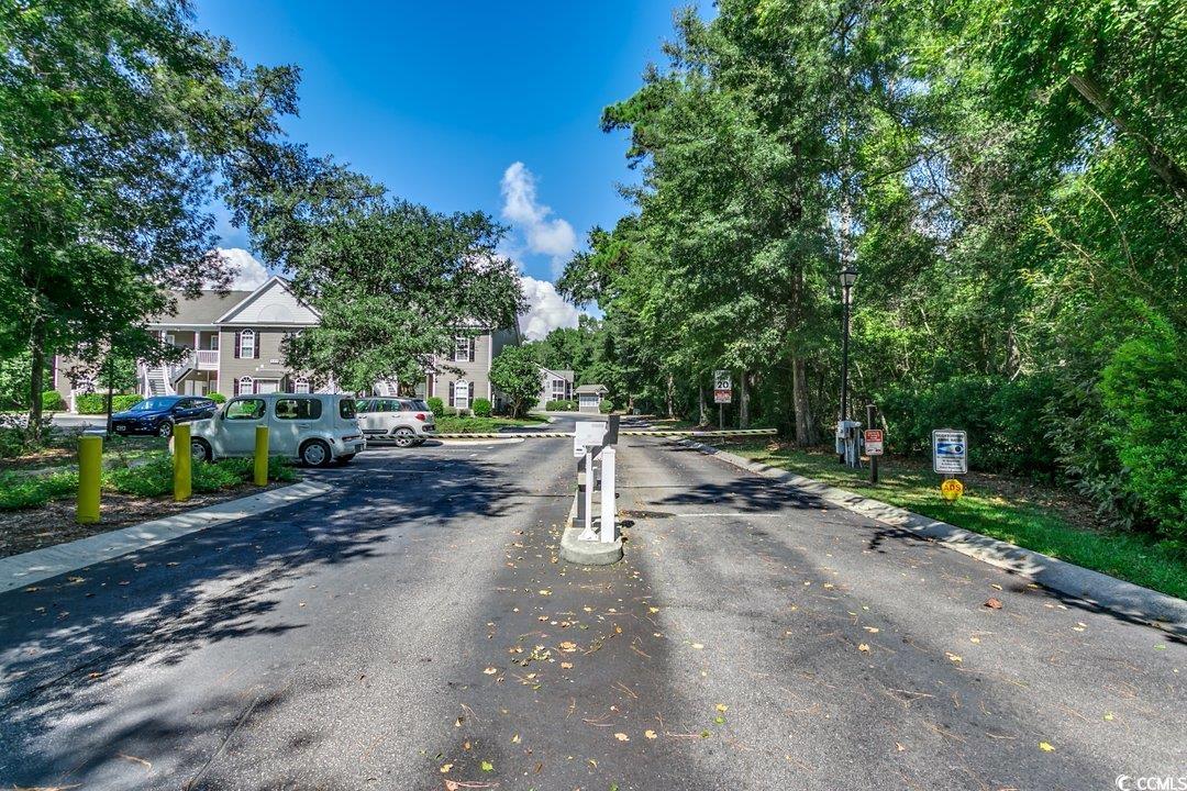 999 Algonquin Drive, Unit E Pawleys Island, SC 29585 - Photo 29 of 37 View of street with traffic signs, curbs, and a gated entry