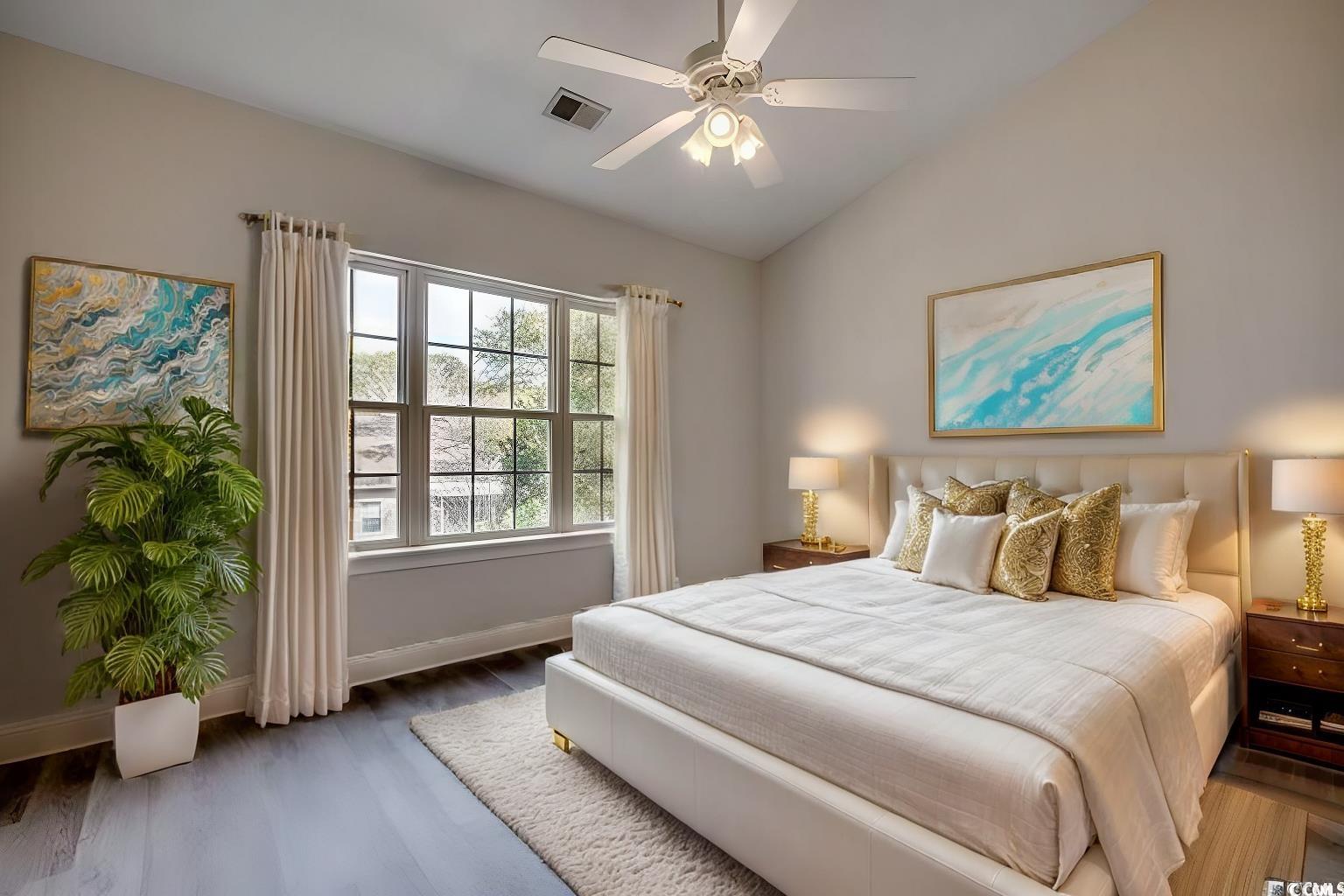 999 Algonquin Drive, Unit E Pawleys Island, SC 29585 - Photo 4 of 37 Bedroom featuring a ceiling fan, wood finished floors, lofted ceiling, baseboards, and visible vents