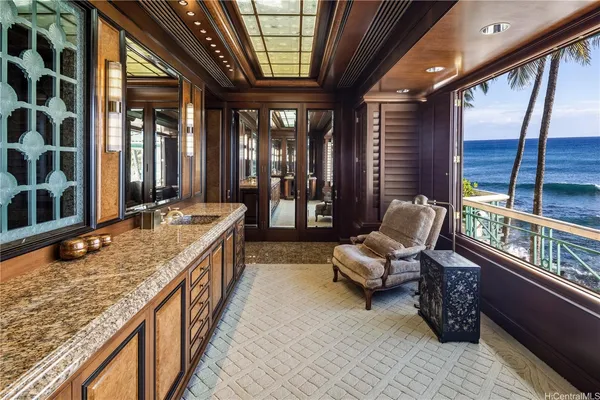 a bathroom with a granite countertop sink and a large window