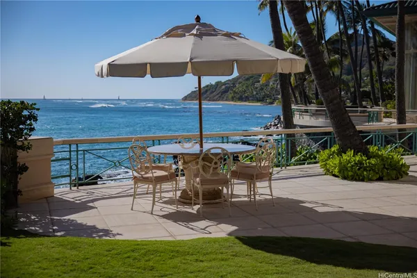 a view of a table and chairs under an umbrella