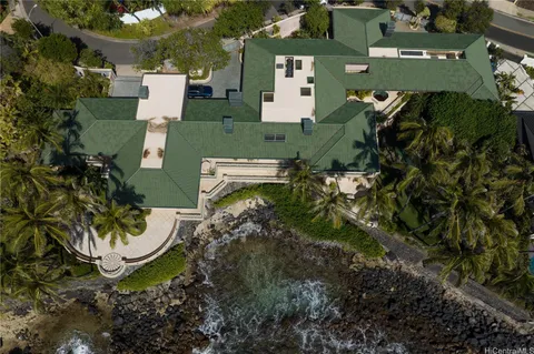 an aerial view of a house with a yard