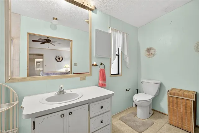 a bathroom with a sink toilet and mirror