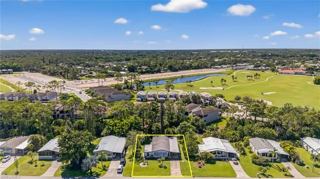 an aerial view of residential houses with outdoor space and swimming pool