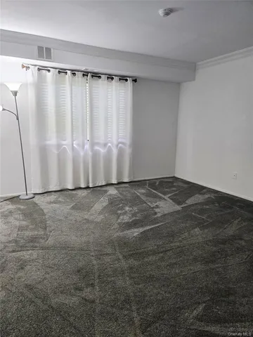 a view of an empty room with walk in closet