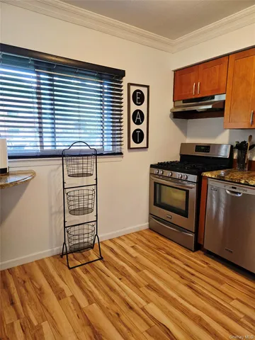 a kitchen with wooden cabinets and a stove top oven