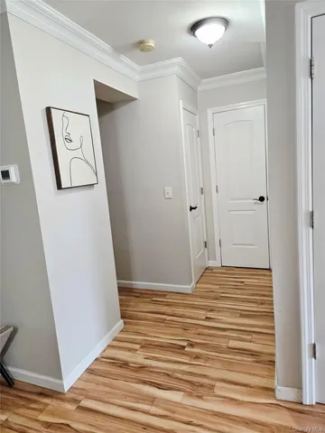 a view of empty room with wooden floor