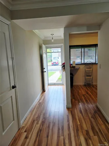 a view of a hallway view with wooden floor and staircase