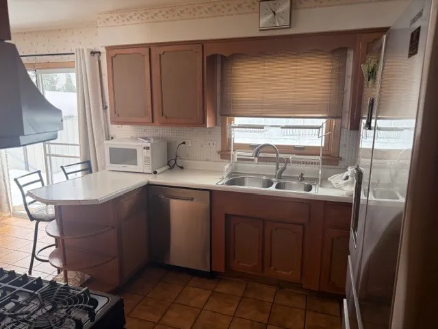 a kitchen with sink cabinets and window