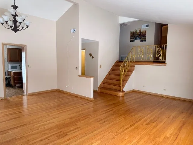 a view of an entryway with wooden floor