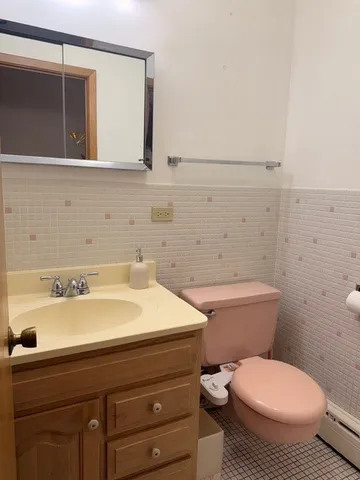 a bathroom with a sink a toilet and mirror