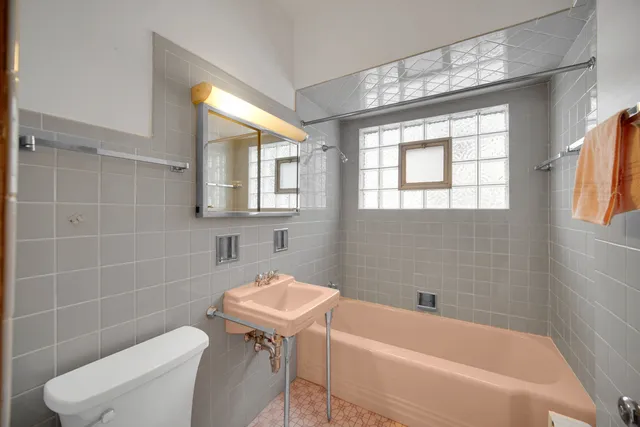 a bathroom with a sink a toilet and bathtub