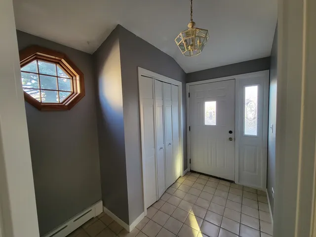 a view of a hallway with windows and entryway