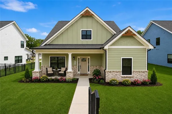 a view of a house with backyard sitting area and garden
