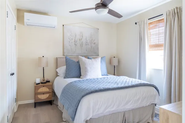 a bedroom with a bed and a chandelier