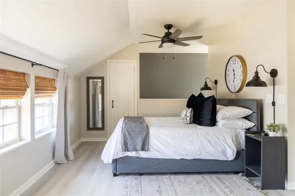 a bedroom with a bed and a chandelier
