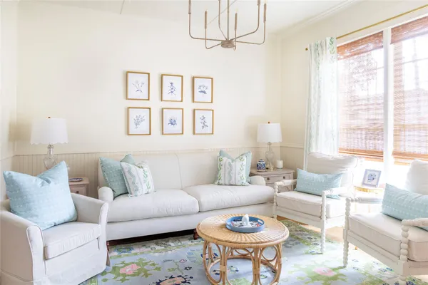 a living room with furniture a rug and a window