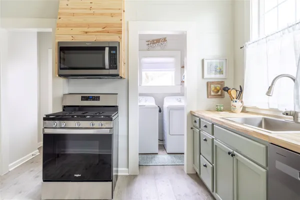 a kitchen with a stove and a window