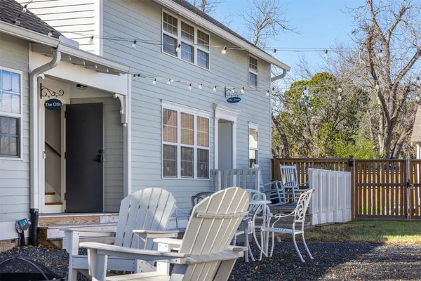 a view of a patio with a table and chairs