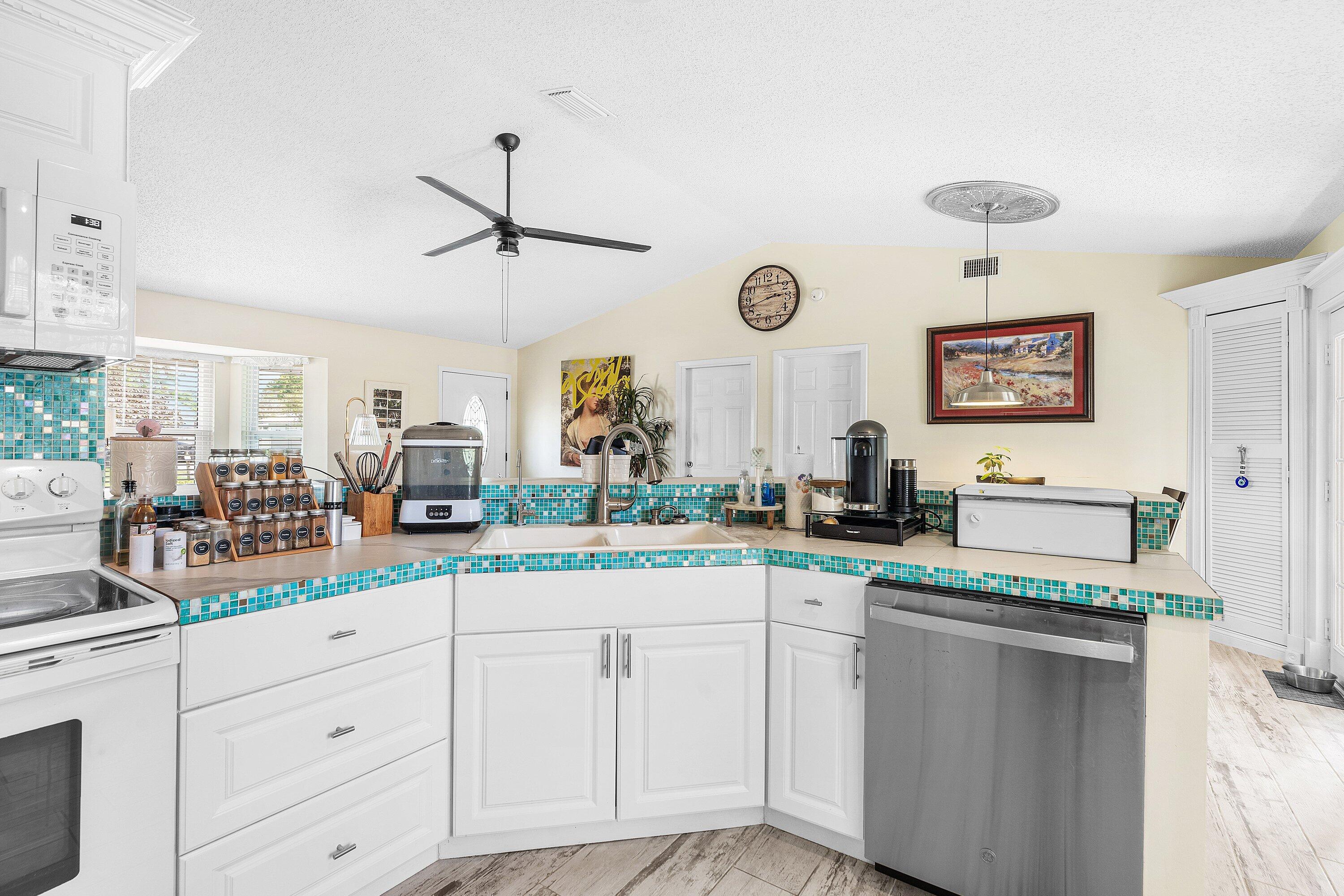 2114 Southeast Midtown Road Port St. Lucie, FL 34952 - Photo 14 of 41 a kitchen with white cabinets and sink