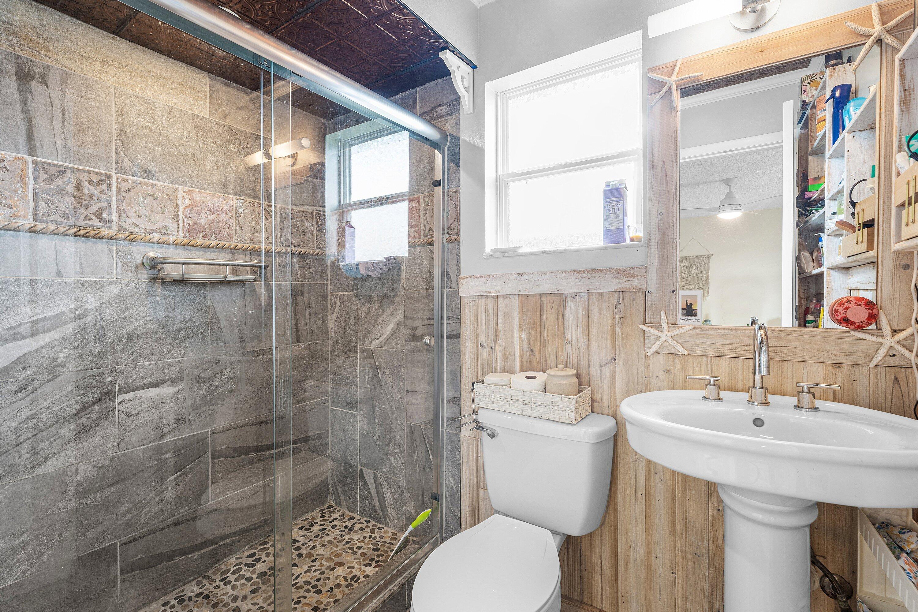 2114 Southeast Midtown Road Port St. Lucie, FL 34952 - Photo 15 of 41 a bathroom with a sink a toilet and shower