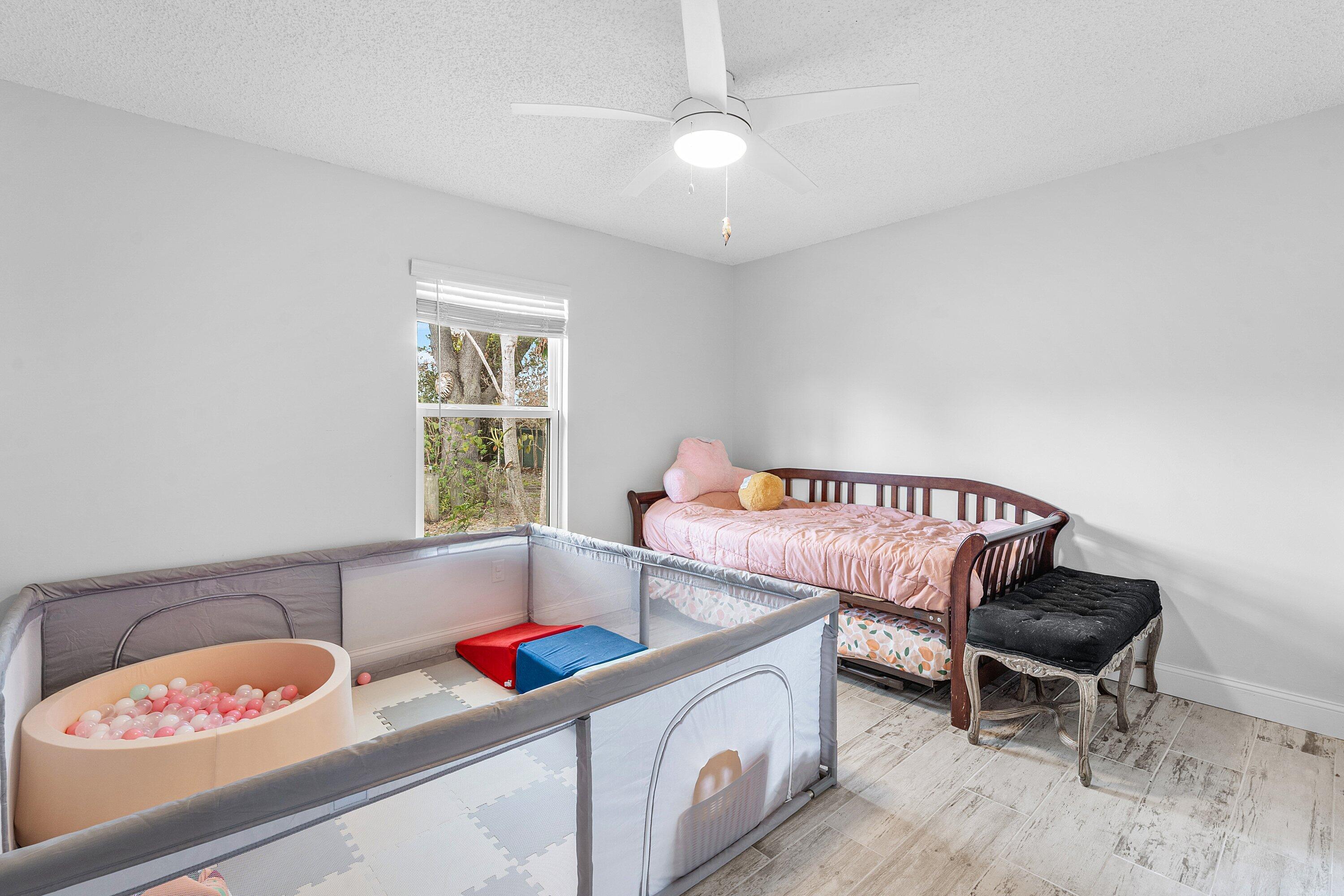 2114 Southeast Midtown Road Port St. Lucie, FL 34952 - Photo 18 of 41 a living room with furniture and a window