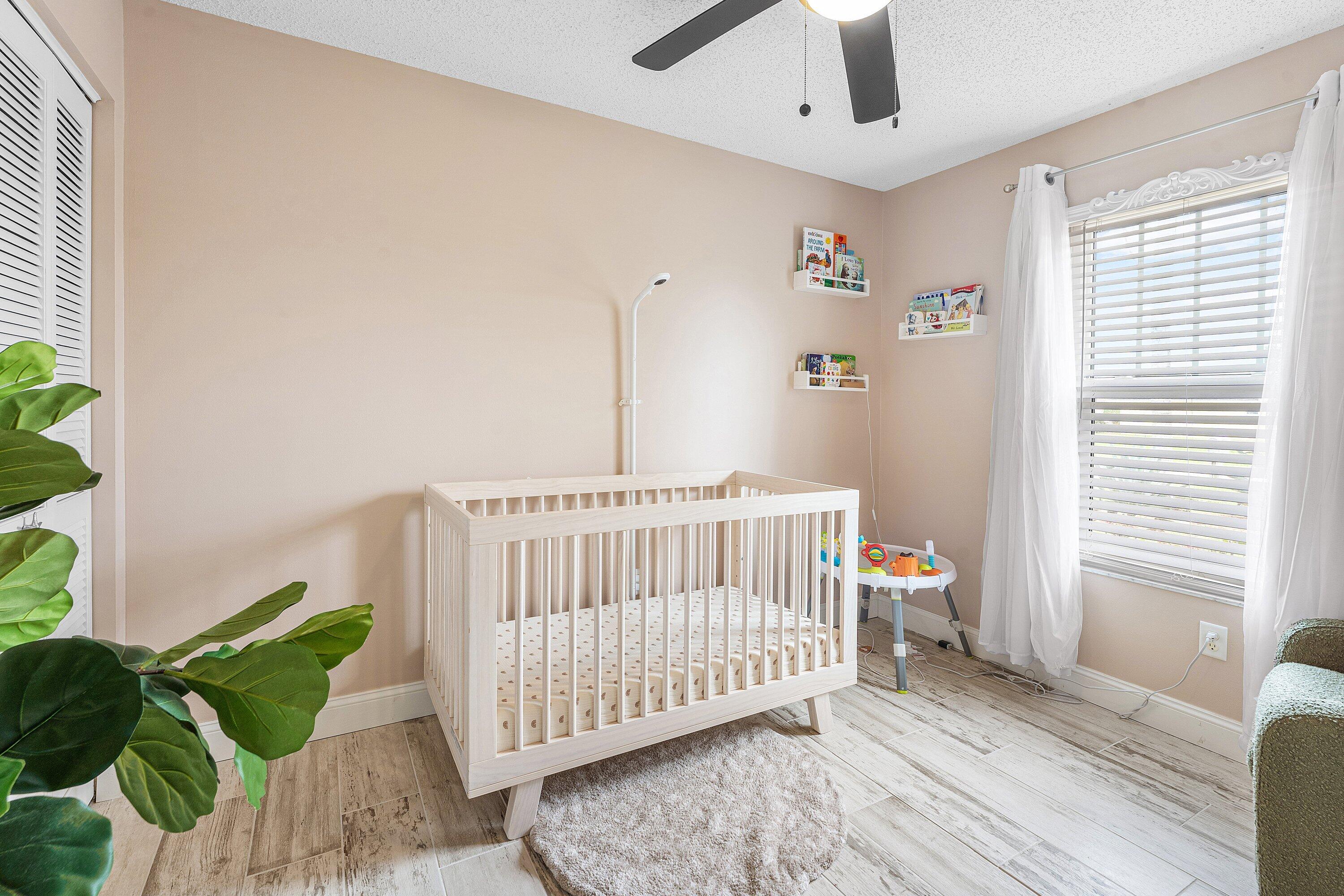 2114 Southeast Midtown Road Port St. Lucie, FL 34952 - Photo 19 of 41 a bedroom with furniture and a window