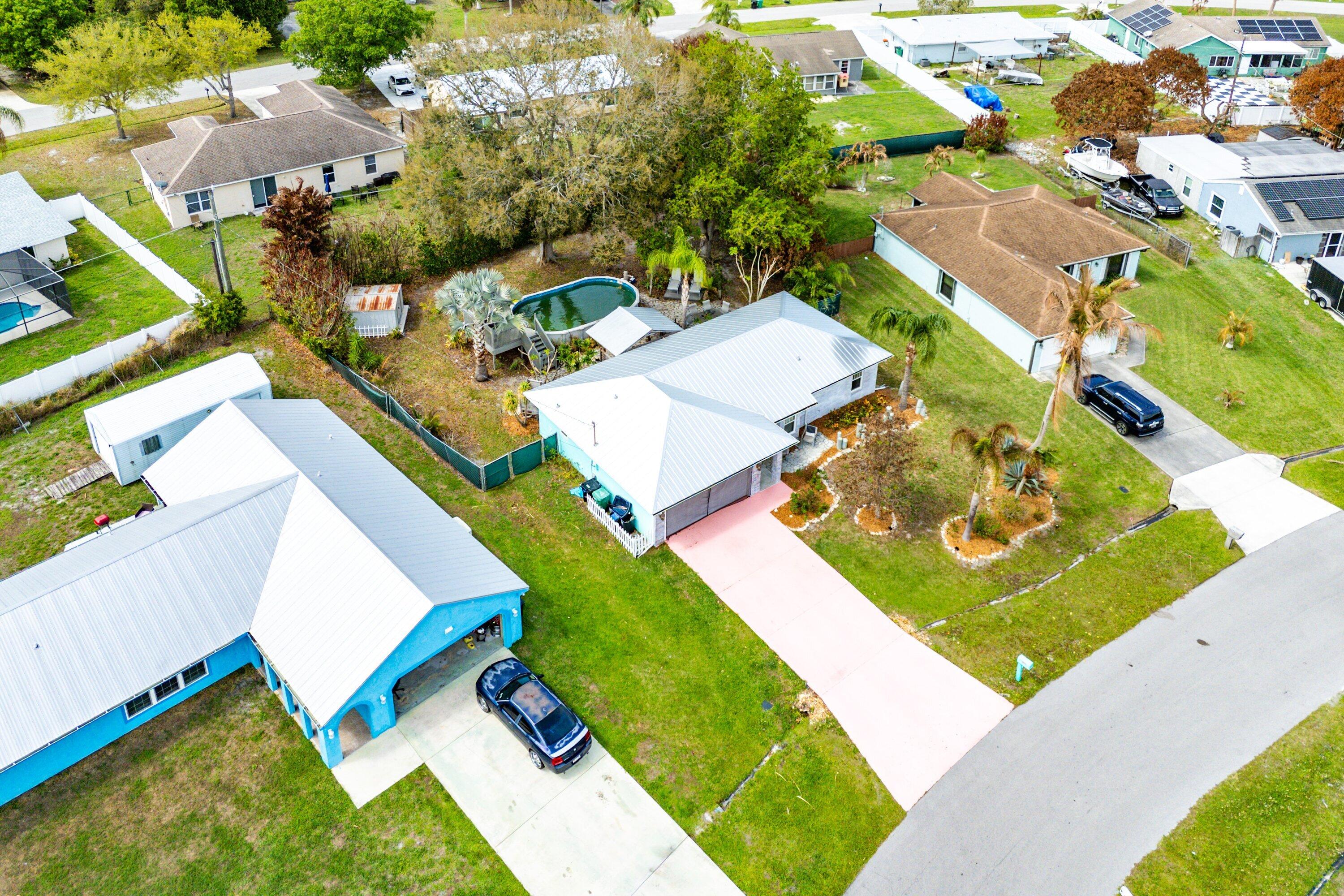 2114 Southeast Midtown Road Port St. Lucie, FL 34952 - Photo 35 of 41 an aerial view of a house with a garden and swimming pool