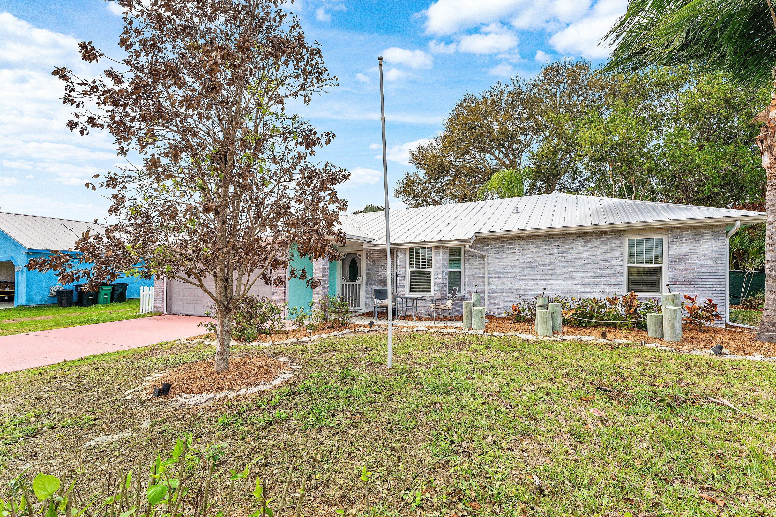 2114 Southeast Midtown Road Port St. Lucie, FL 34952 - Photo 4 of 41 a backyard of a house with table and chairs