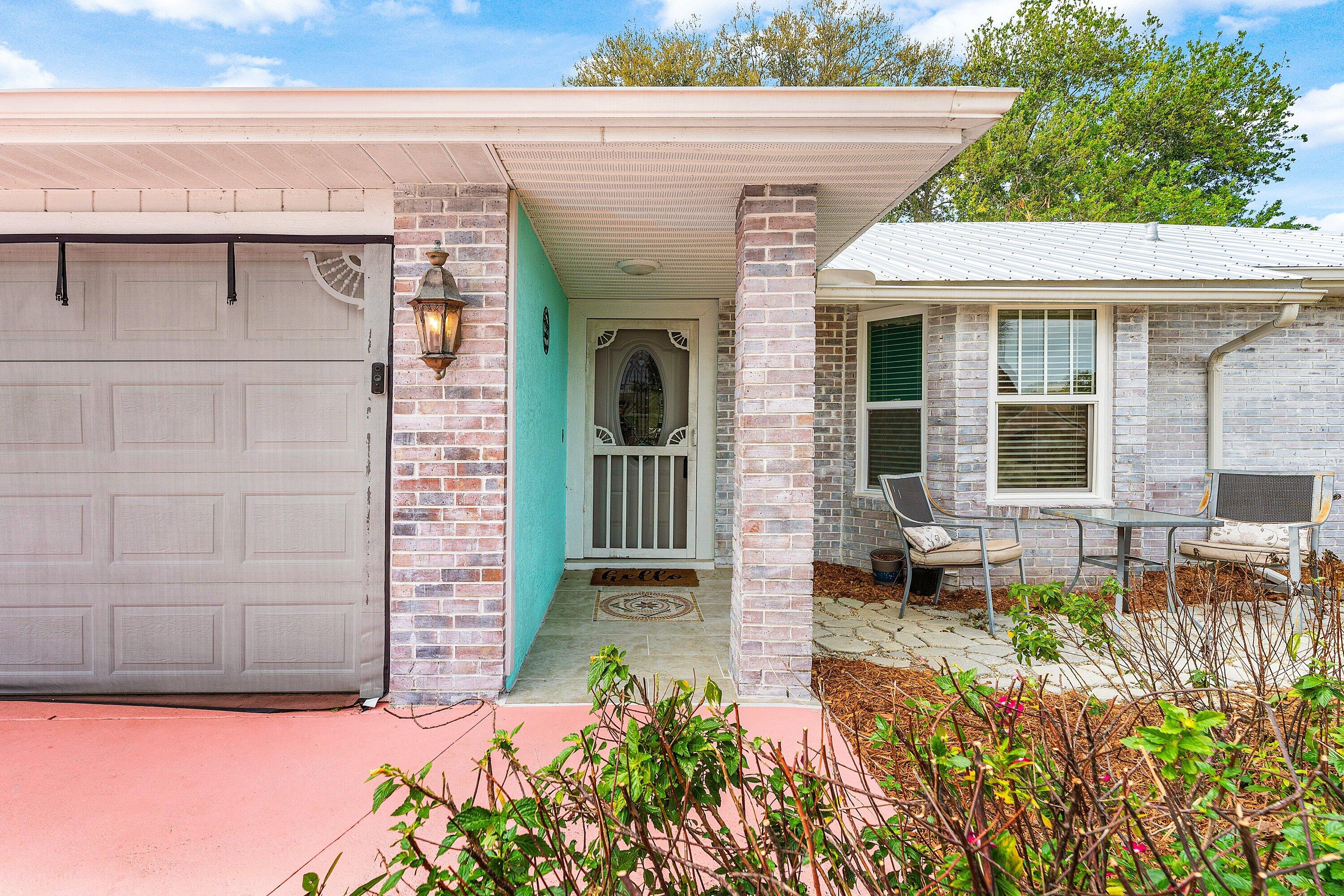 2114 Southeast Midtown Road Port St. Lucie, FL 34952 - Photo 5 of 41 a view of a house with potted plants