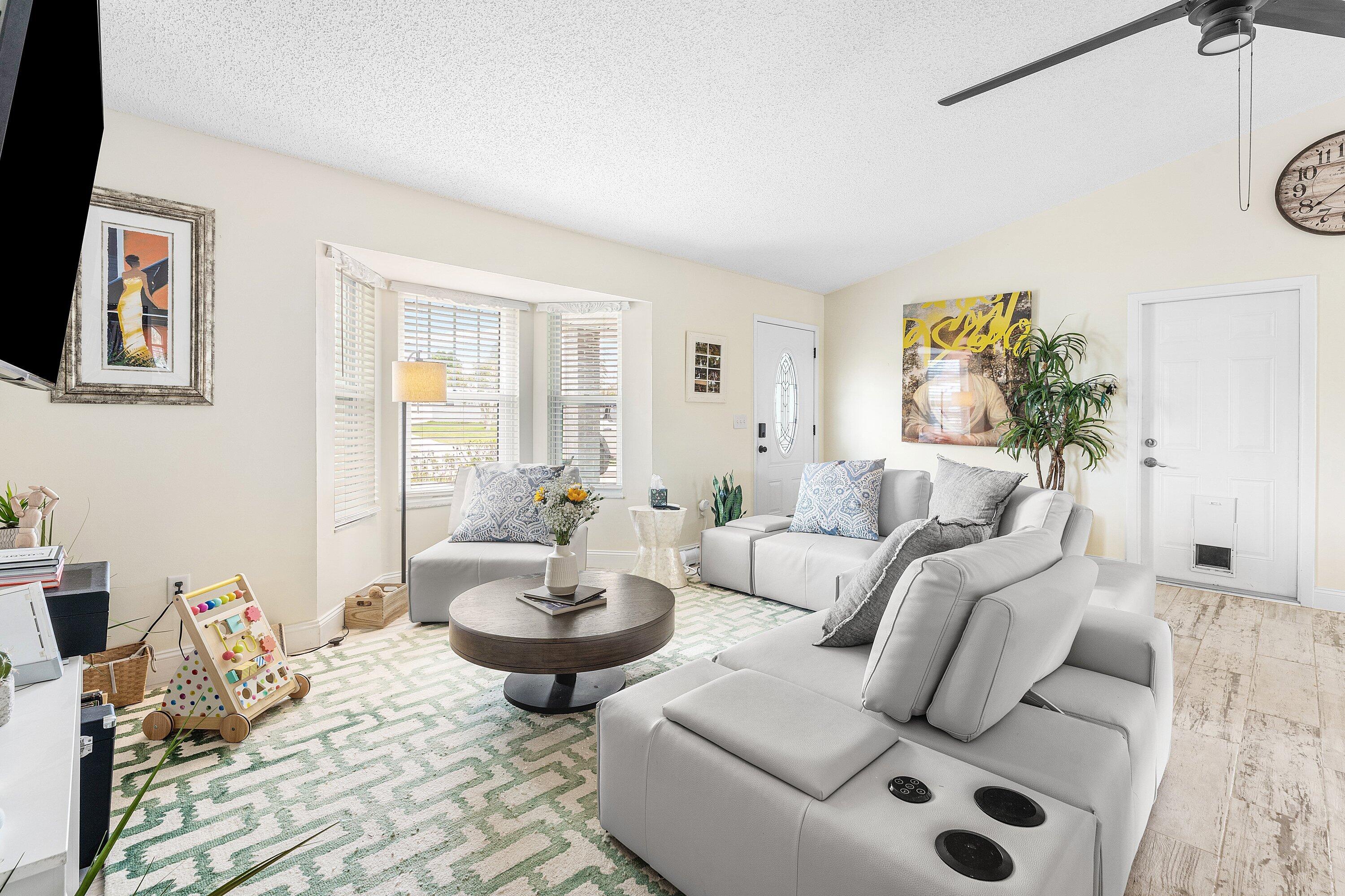2114 Southeast Midtown Road Port St. Lucie, FL 34952 - Photo 6 of 41 a living room with furniture and a large window