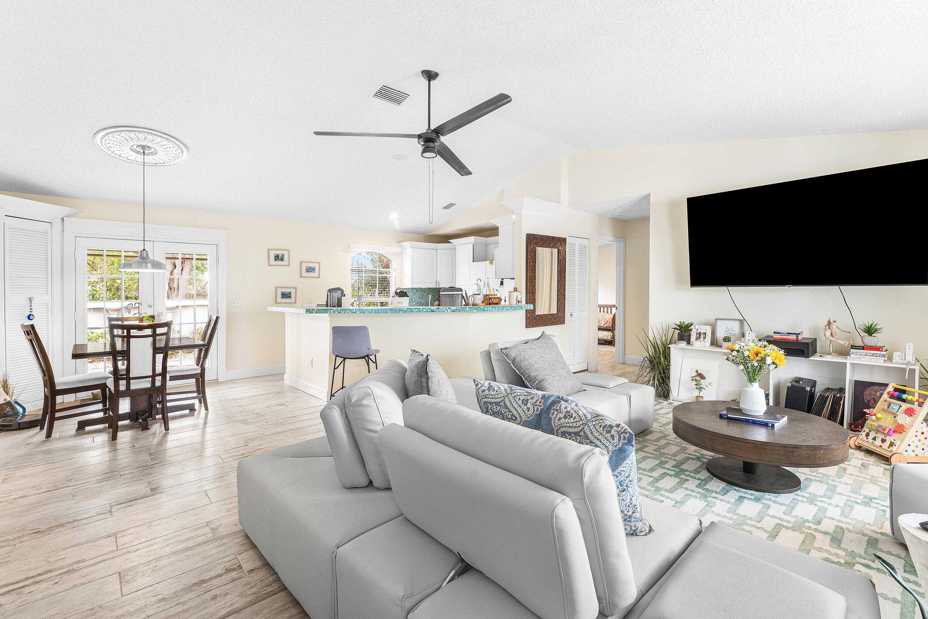 2114 Southeast Midtown Road Port St. Lucie, FL 34952 - Photo 8 of 41 a living room with furniture and a flat screen tv