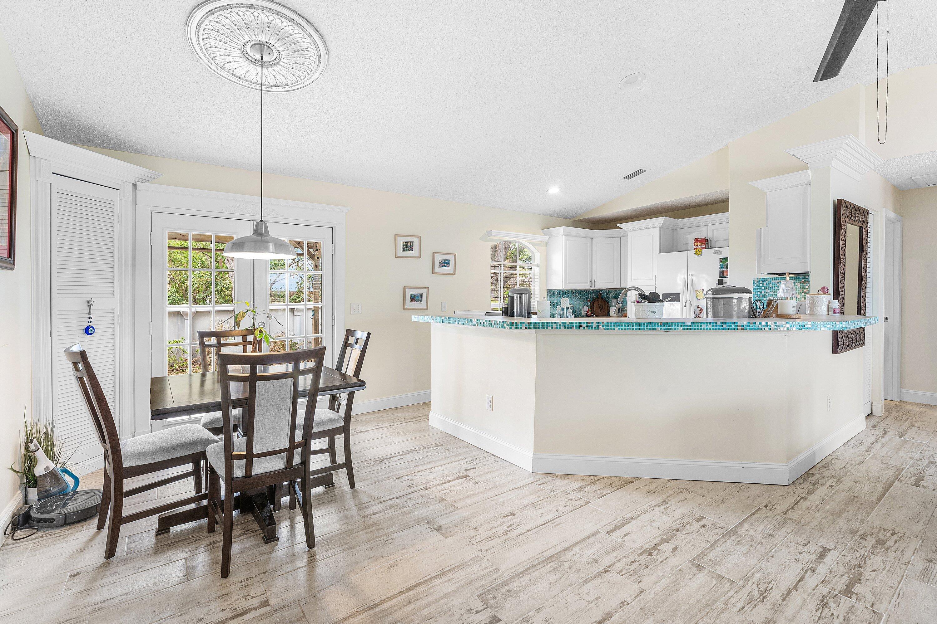 2114 Southeast Midtown Road Port St. Lucie, FL 34952 - Photo 9 of 41 a living room with stainless steel appliances kitchen island granite countertop furniture and a kitchen view