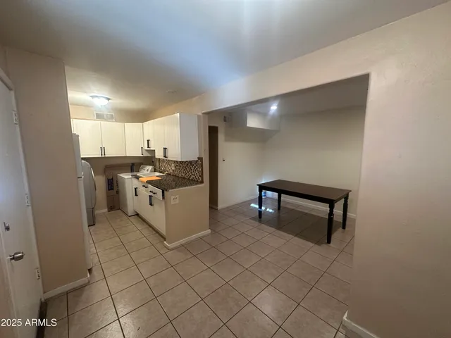 a kitchen with cabinets and wooden floor