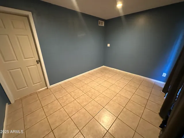 a bedroom with a bed and a mirror