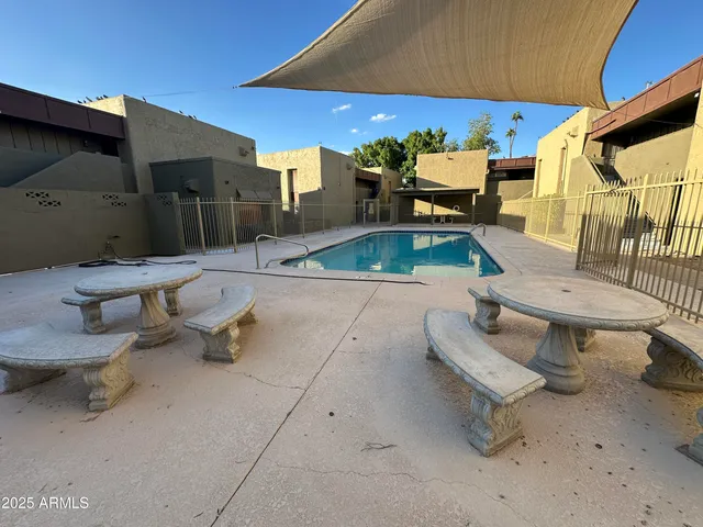 a backyard of a house with table and chairs