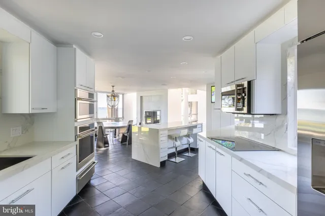 a large kitchen with a table and chairs