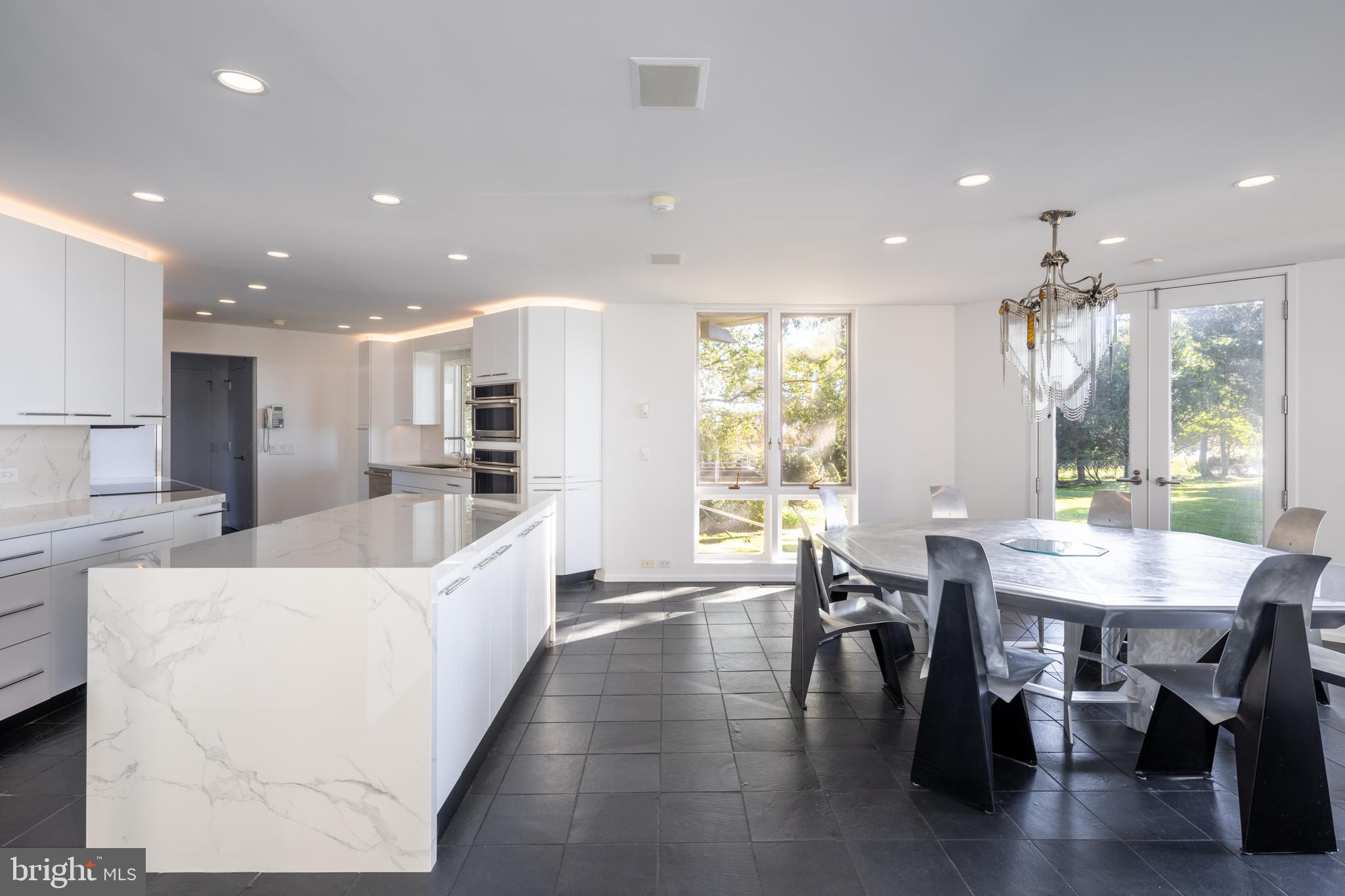 5084 Ferry Neck Road Royal Oak, MD 21662 - Photo 15 of 58 a large kitchen with a table and chairs